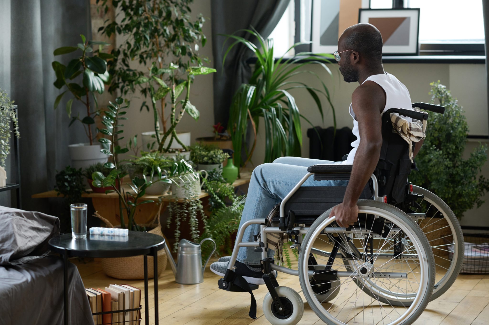 man-with-disability-sitting-at-home-alone-2022-06-08-16-29-48-utc-2048x1365